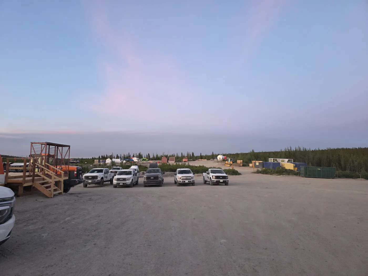 WhiteRock's field vehicle fleet at the Banana Lithium Project camp at dusk